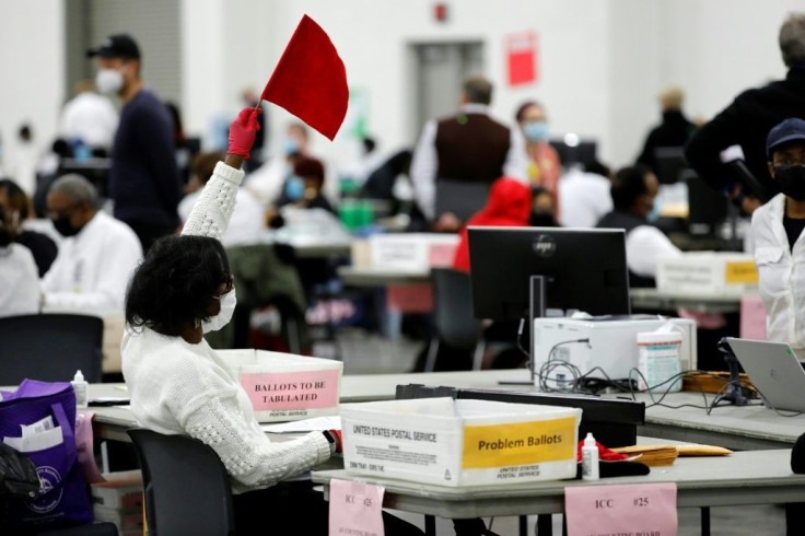 An election worker seeks assistance while counting absentee ballots in Detroit, Michigan