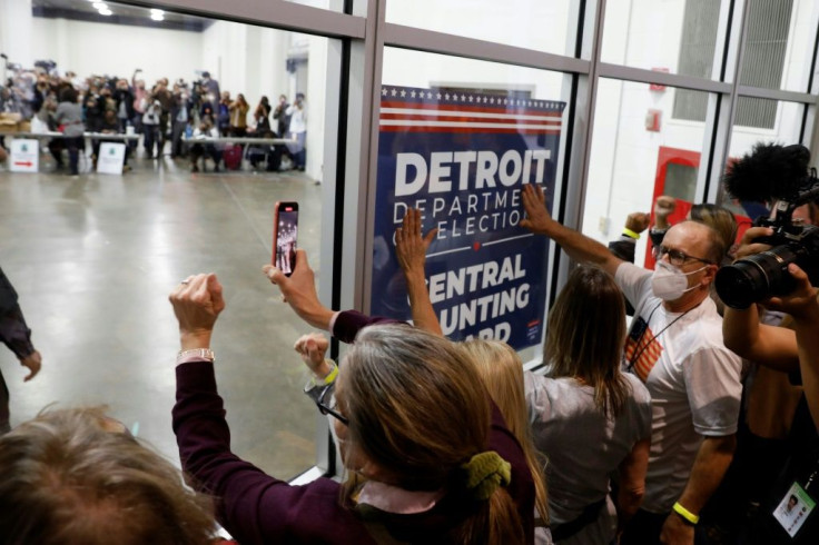 Supporters of US President Donald Trump bang on the glass and chant slogans outside the room where absentee ballots for the 2020 general election are being counted at on November 4, 2020 in Detroit