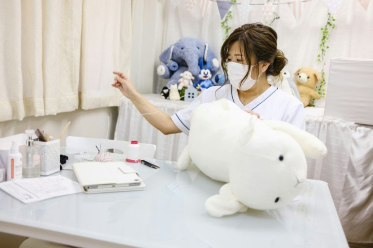 Natsumi Hakozaki restores client Yui Kato's stuffed toy sheep Yuki-chan at Natsumi Clinic in Toyko