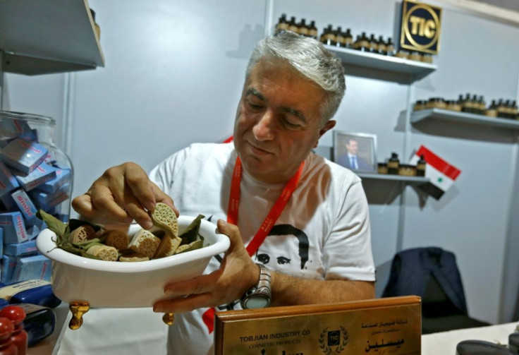 Joseph Tobjian, a 61-year-old Syrian soap maker arranges Aleppo soap products