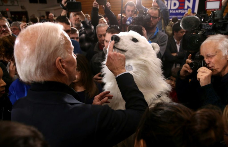 Democratic presidential candidate former Joe Biden taps the nose of a person in a polar bear costume during a campaign event in New Hampshire; the United States' future participation in the Paris climate accord rests on the 2020 election