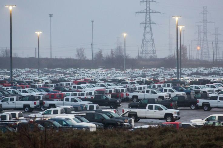 GM says it will bring back production of pickups at its Oshawa, Ontario assembly plant, which had been closed in December 2019. Hundreds of Silverado pickups assembled at the plant are seen here in November 2018 outside the facility