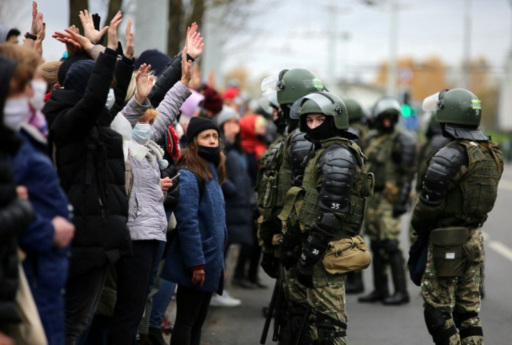 Belarusian law enforcement officers block protesters during a march of opposition supporters from central Minsk to a site of Stalin-era executions just outside the capital on November 1, 2020