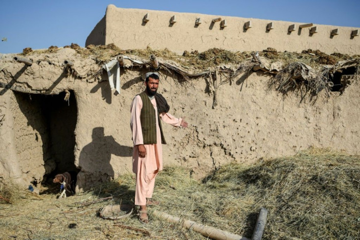 Farmer Atta Jan, 28, shows a wall hit by bullets at his house in Kandahar province