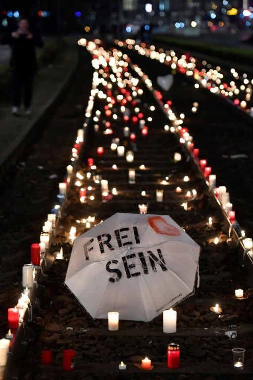 A protester's umbrella emblazones with the motto 'Be free' (Frei sein)