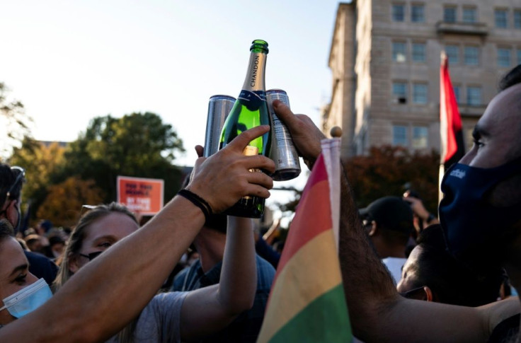 People celebrate Joe Biden's election, on Black Lives Matter plaza across from the White House