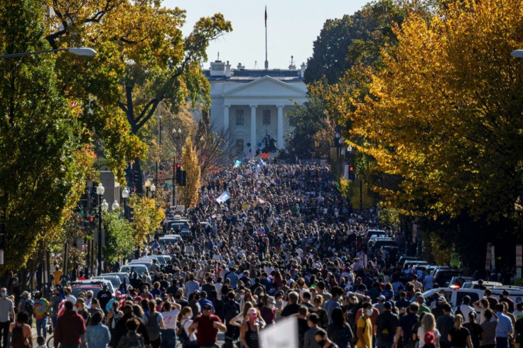 People celebrate on Black Lives Matter plaza across from the White House, after Joe Biden is declared winner of the 2020 presidential election