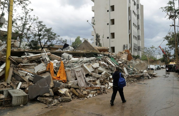 A man walks past a building in Beirut's Karantina neighbourhood that was damaged by the August 4 port blast and collapsed due to heavy rain