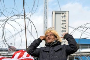 An activist impersonating Donald Trump celebrates Joe Biden's election victory on the US-Mexican border