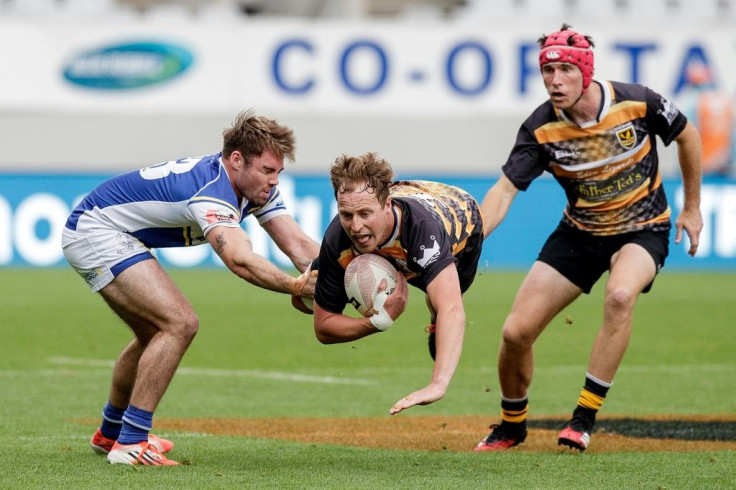 Auckland University Squids Matt Jones tackles Eden Lizards Matt Turner (C) during the U85 Club Cup Final at Eden Park. New Zealand Rugby set up a national tournament this year that allows only players weighing 85 kilograms (187lb, 13st 5lb) or less to com