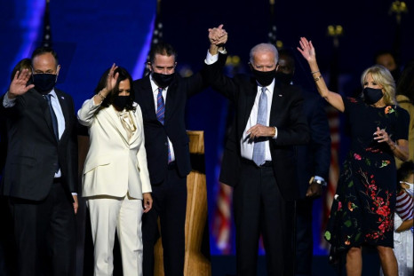 (From L) Husband of Vice President-elect Kamala Harris, Douglas Emhoff, Vice President-elect Kamala Harris, Hunter Biden, US President-elect Joe Biden and wife Jill Biden salute the crowd after delivering remarks in Wilmington, Delaware, on November 7, 20