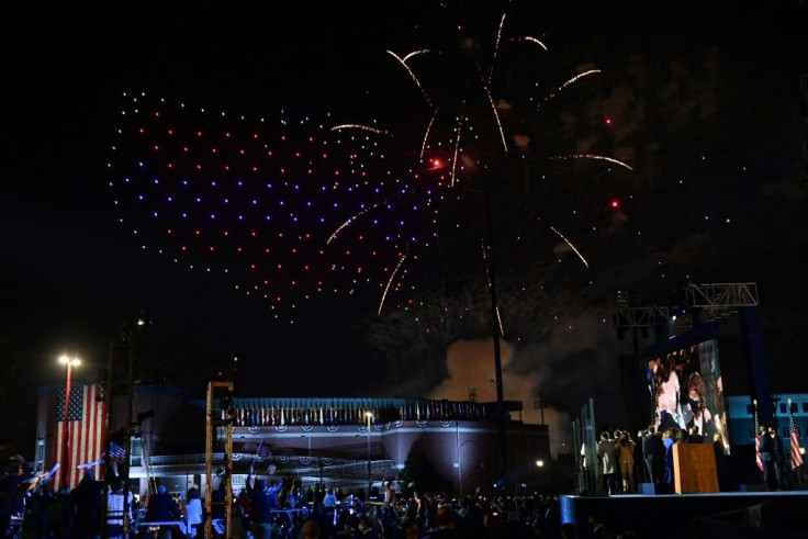 Fireworks are launched as illuminated drones create the shape of the United States of America in the sky as US President-elect Joe Biden with his wife doctor Jill Biden alongside Vice President-elect Kamala Harris and her husband Douglas Emhoff and their 