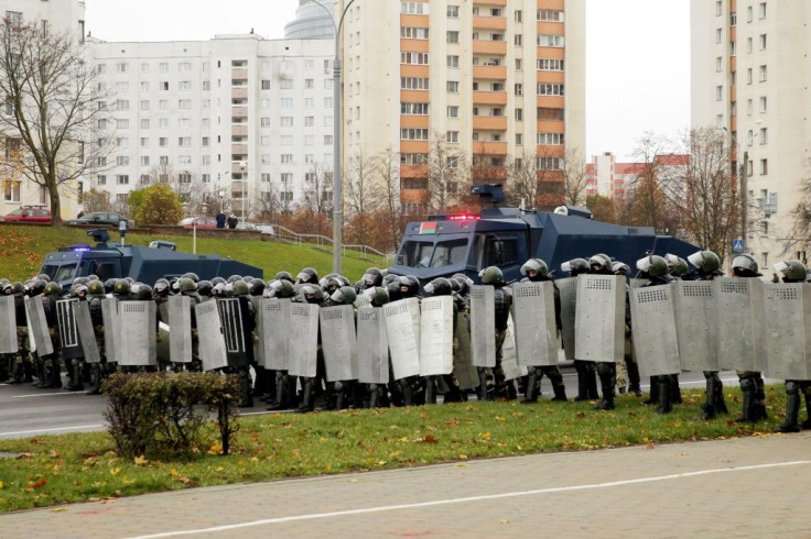 Law enforcement officers block the road as opposition supporters hold their latest rally to protest the Belarus presidential election results three months ago.