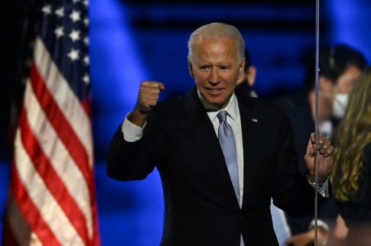 US President-elect Joe Biden pumps his first after delivering his victory speech in Wilmington, Delaware