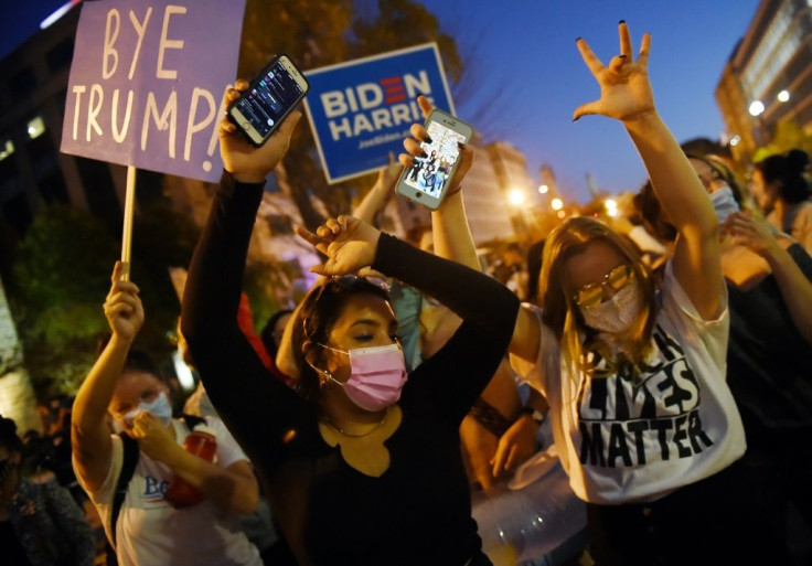 Supporters of President-elect Joe Biden celebrate on Black Lives Matter Plaza across from the White House