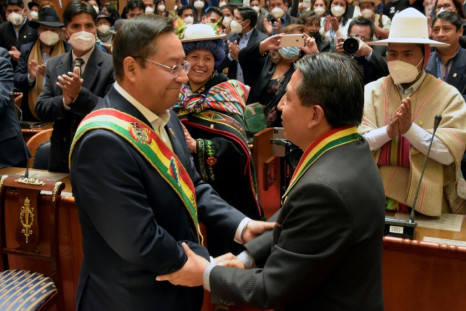 Luis Arce (L) and Vice President David Choquehuanca greet one another at a swearing-in before parliamentarians and foreign dignitaries in La Paz on November 8, 2020