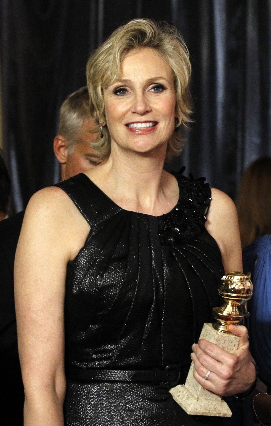 Actress Jane Lynch holds her award for Best Performance by an Actress in a Supporting Role in a Series, Mini-Series or Motion Picture Made for Television at the Warner Bros. and InStyle after-party for the 68th annual Golden Globe Awards in Beverly Hills,
