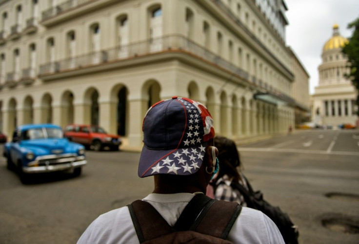 A man wearing a cap with a US flag design walks along a street of Havana, on November 3, 2020, the day of the American presidential election