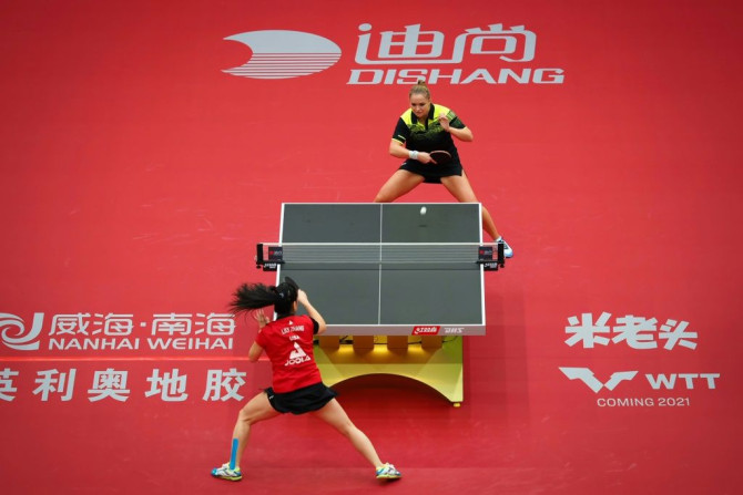 Lily Zhang (in red) of the United States plays Margaryta Pesotska of Ukraine at the 2020 ITTF Women's World Cup in Weihai, the first event on the sport's world tour since the virus shutdown