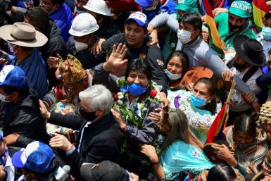 Bolivia's former president Evo Morales waves behind ex-vice-president Alvaro Garcia as he returns to Bolivia after a year in exile, with supporters greeting him in Villazon on November 9, 2020