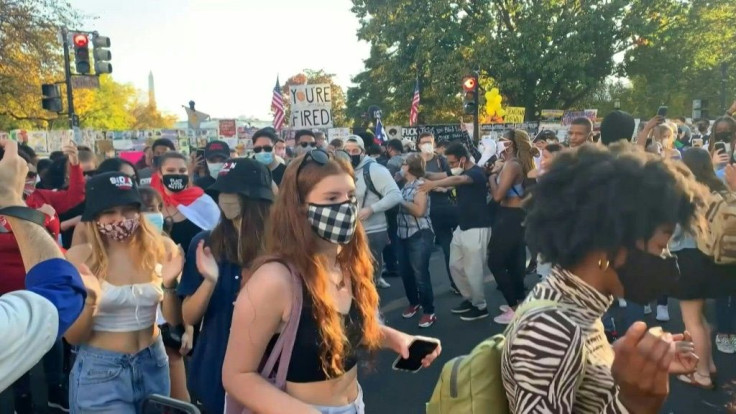 Americans dance at Black Lives Matter plaza near the White House to celebrate Joe Biden's victory in the US presidential election