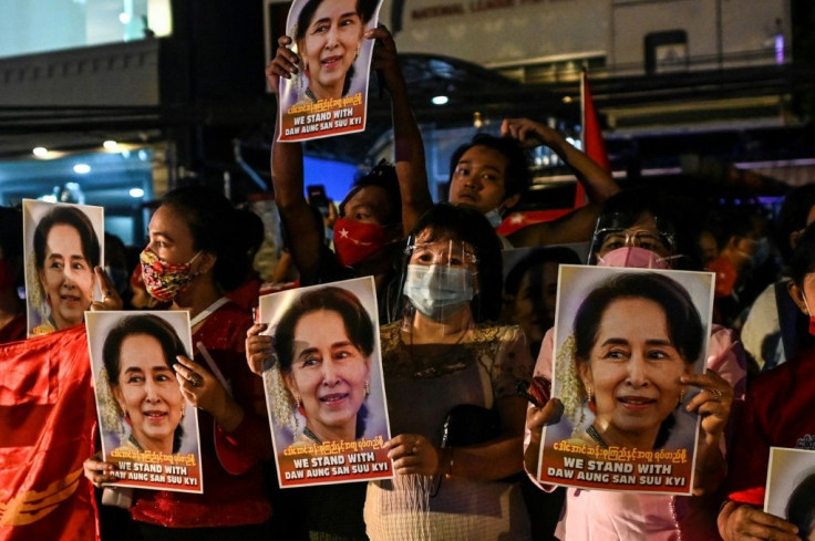 Supporters of Myanmar's National League for Democracy (NLD) hold posters with the image of Nobel laureate Aung San Suu Kyi, the country's civilian leader, as they celebrate what they say is a landslide victory in elections