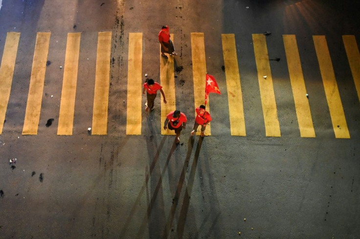 Supporters of the National League for Democracy (NLD) celebrate the party's apparent landslide election win