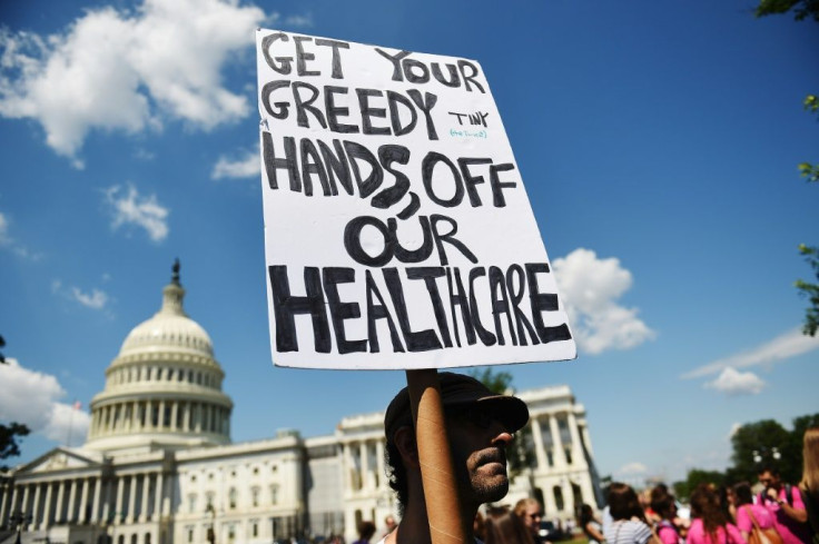 A protester holds a sign during a demonstration opposing the repeal of the Affordable Care Act