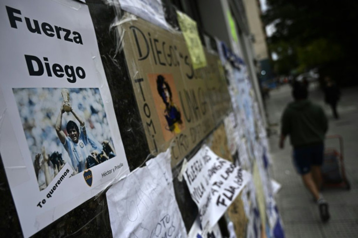 Messages of support are seen outside the private clinic where Argentine former football star and coach of Gimnasia y Esgrima La Plata Diego Maradona underwent a brain surgery for a blood clot, in Olivos, Buenos Aires Province, on November 9, 2020