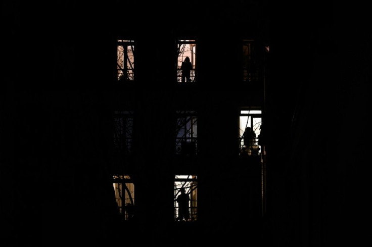 People stand by their windows and applause in solidarity with healthcare workers on the frontline of the coronavirus outbreak in Paris in March