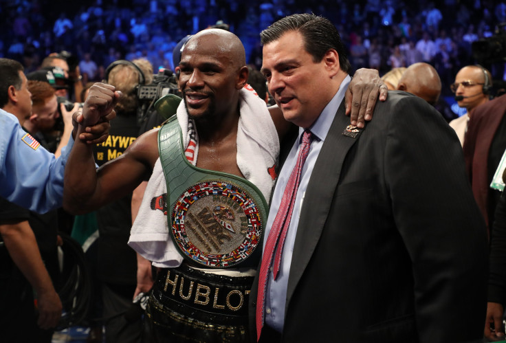 Floyd Mayweather Jr. celebrates with WBC President Mauricio Sulaiman and the WBC Money Belt after his TKO of Conor McGregor in their super welterweight boxing match