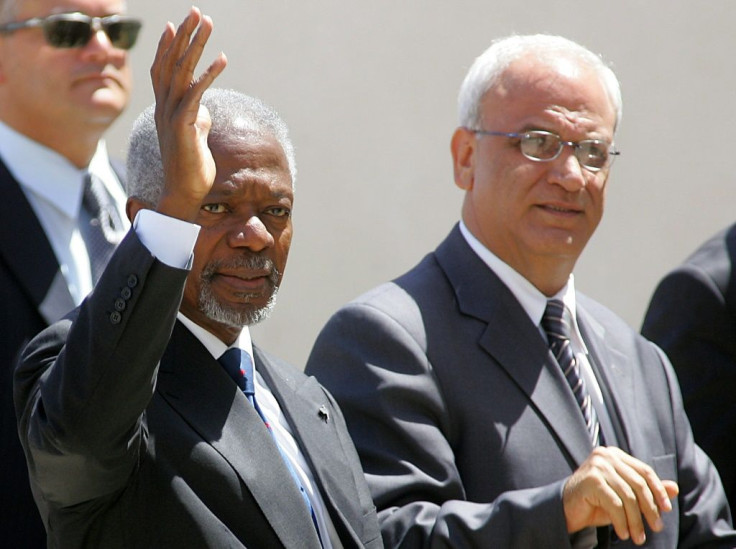 In this file photo taken on August 30, 2006, then UN Secretary General Kofi Annan (L) and Palestinian chief negotiator Saeb Erekat wave as Annan arrives at Palestinian Authority headquarters in the West Bank city of Ramallah