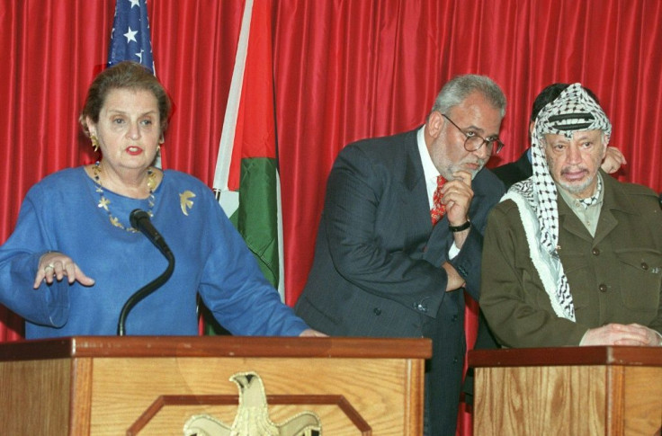 In this file photo taken on October 7, 1998, then Palestinian Authority President Yasser Arafat listens to a translation of US Secretary of State Madeleine Albright press conference by senior Palestinian negotiator Saeb Erekat in Jericho