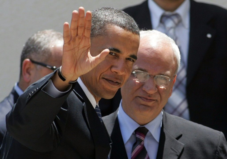 In this photo taken on July 23, 2008, then US Senator and Democratic presidential candidate Barak Obama waves to the press as he is welcomed by Senior Palestinian negotiator Saeb Erakat in the West Bank city of Ramallah