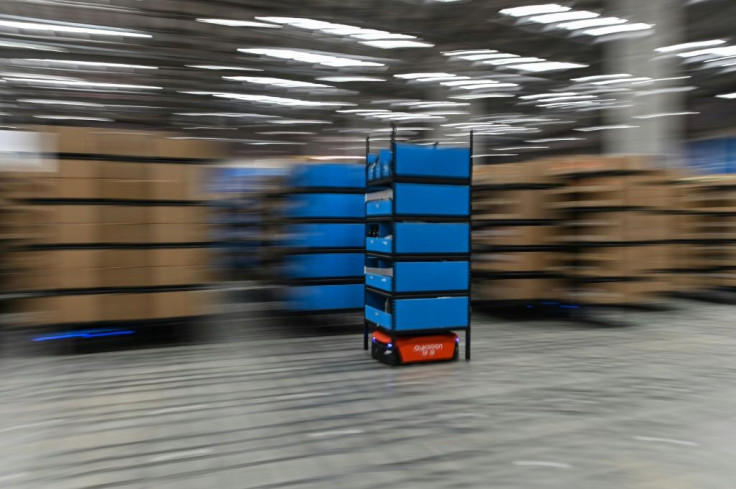 A blue robot moves between aisles at the Wuxi warehouse of Cainiao Smart Logistics Network, an affiliate of e-commerce giant Alibaba, ahead of Singles Day