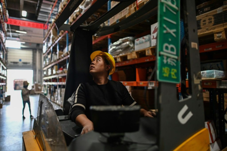 A forklift operator looks for products at a distrubition centre in Jiangsu province