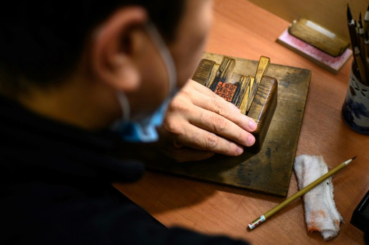 Traditional ink stamp-maker Takahiro Makino working on a hanko in Tokyo