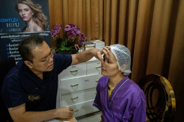 Thai surgeon Sakirin Al-Ishak prepares Somprasong Aimsantia for plastic surgery on her nose at the Vayo Clinic in Bangkok