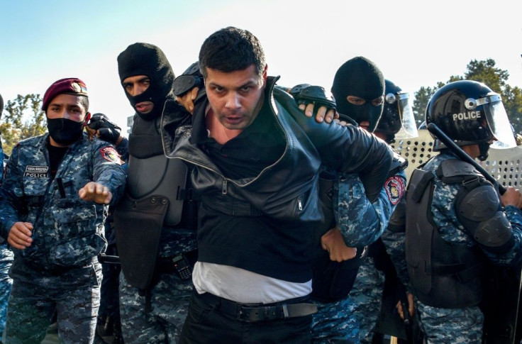 Armenian police detain a protestor during a rally against the country's agreement to end fighting with Azerbaijan over the disputed Nagorno-Karabakh region