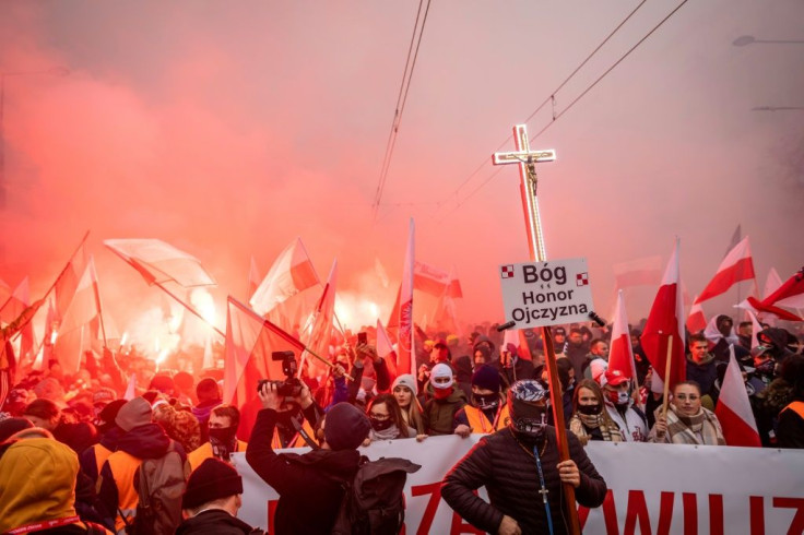 Protesters threw stones and firecrackers during the Independence Day march in Warsaw. Many waved Polish flags and chanted: 'God, honour and homeland!'