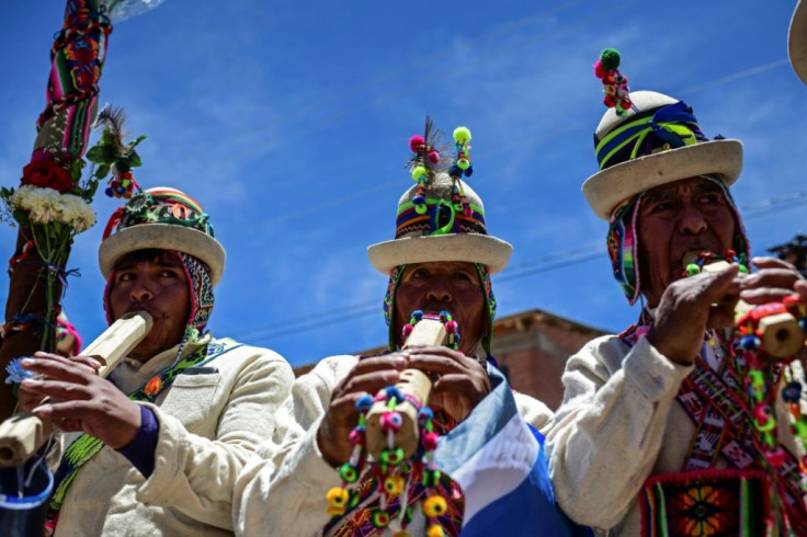 Supporters of ex-president Evo Morales play instruments as crowds welcome his arrival in Orinoca, Bolivia