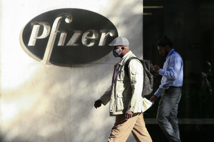 People walk by the Pfizer world headquarters in New York on November 9, 2020