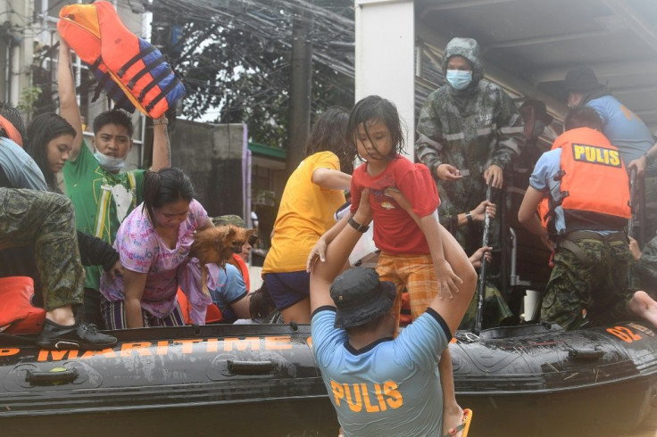 Rescuers evacuate residents from their flooded homes
