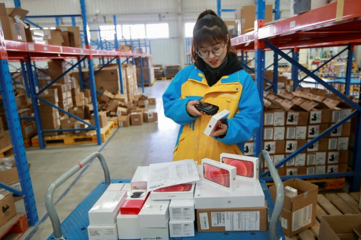 An employee checks items to be delivered to customers on Singles' Day, also known as the Double 11 shopping festival, at the warehouse of Suning Logistics Network in Shenyang