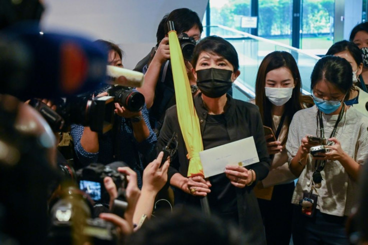 Pro-democracy lawmaker Claudia Mo holds a yellow umbrella and her resignation letter at the Legislative Council in Hong Kong on November 12, 2020