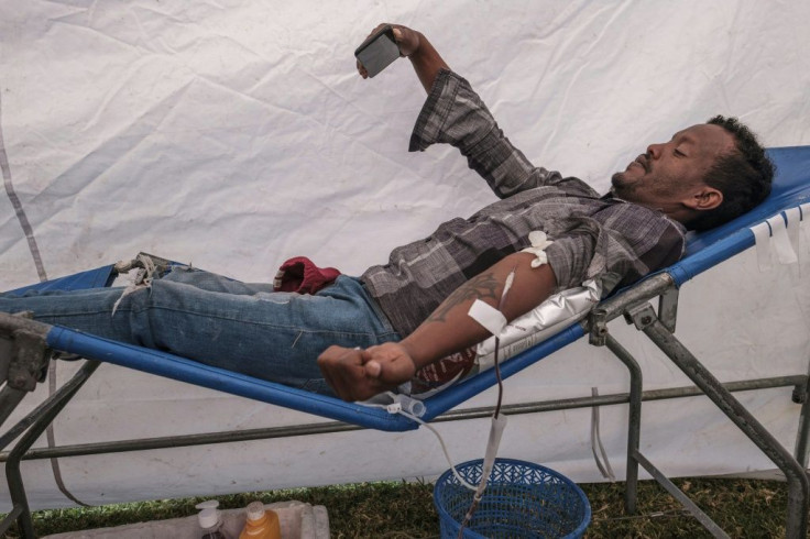 A man takes a selfie as he donates blood at the rally in Addis, organised by the city administration