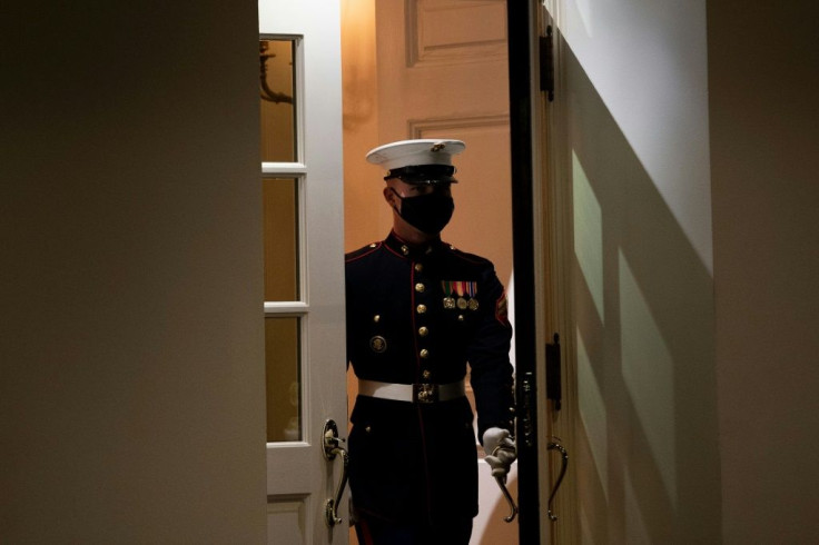 A Marine arrives to stand guard outside the West Wing of the White House