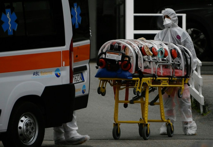 Medical workers arrive at a hospital in Naples in an ambulance with a COVID-19 patient