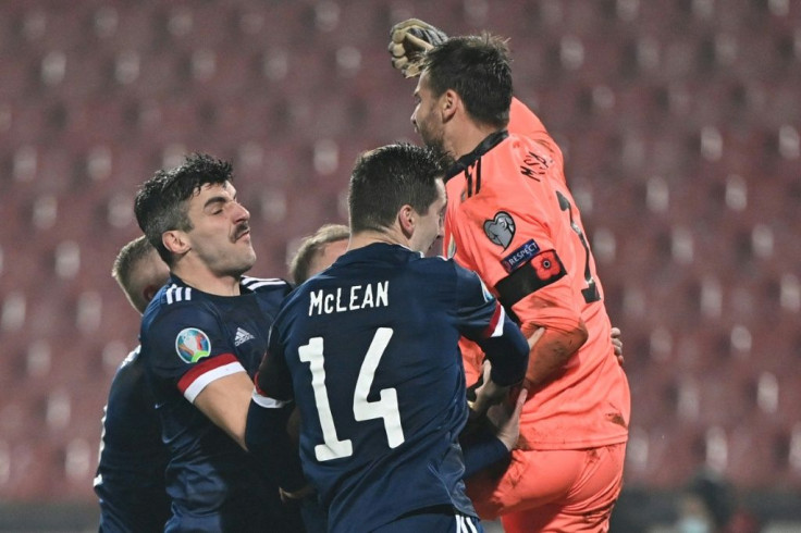Scotland goalkeeper David Marshall celebrates with his teammates after his penalty save against Serbia sealed their place at Euro 2020
