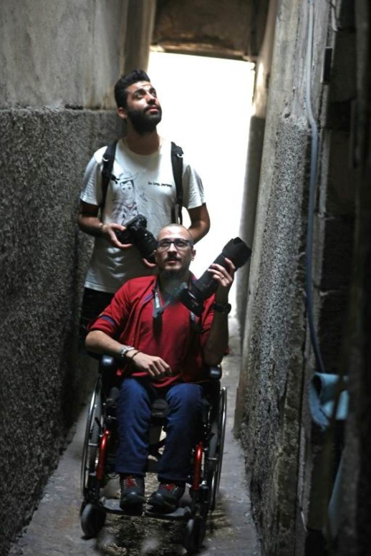 Bader al-Hajjami leads the way as he and his friend Ahmad Moussa set out to take photographs in an alley of Syria's capital Damascus
